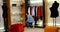 Slender young girl chooses shoes to her outfit in the store.