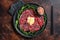 Slice Of beef Carpaccio, arugula and Parmesan. Dark background. Top view
