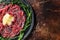 Slice Of beef Carpaccio, arugula and Parmesan. Dark background. Top view. Copy space
