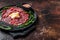 Slice Of beef Carpaccio, arugula and Parmesan. Dark background. Top view. Copy space