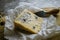 Slice of blue cheese cheese on wooden board with cheese knife, closeup view