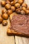 Slice of bread with chocolate with hazelnuts on wood