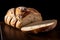 Slice of bread on a dark background. The bread stands out with its crispy crust and soft interior.