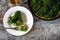 Slice of broccoli frittata on a white plate.