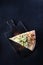 A slice of Caesar pizza on a wooden serving board. Flat lay. Top view. Copy space.