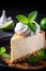 a slice of cheesecake with whipped cream and mint leaves