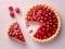 A slice of cherry pie is cut in half and sits on a plate