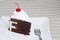 Slice of chocolate black forest cake with a cherry