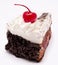 Slice of chocolate cake with cherry on the top isolated