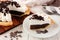 Slice of chocolate cream pie, close up table scene against white wood