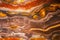 Slice of colored bands of iron formation in igneous rock with swirls and fascinating patterns - background