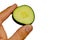Slice of cucumber Cucumis Sativus held between adult man thumb and index finger on white background