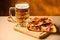 Slice of delicious homemade pizza served with light cold beer on