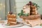 Slice of delicious naked chocolate and hazelnuts cake on table rustic wood kitchen countertop