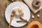 Slice of fresh homemade pumpkin pie and semolina on a white plate on a wooden background. . A Thanksgiving or holiday treat.