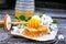 slice of fresh honey sat and bowl with yellow honeycomb with acacia flowers