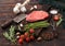 Slice of fresh raw barbeque braising beef steak on chopping board with asparagus and garlic with tomatoes and salt with pepper on