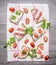 Slice of fresh rye bread with cream cheese with red fish, cherry tomatoes and salami parsley on a striped tablecloth on w
