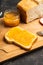 Slice of freshly baked rural bread with homemade citrus jam. Selective focus