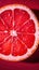 Slice of grapefruit. Red grapefruit background. Composition of half Orange.