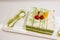 Slice green tea cake on white plate