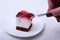 Slice of handmade cherry pie on a plate in white background