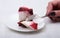 Slice of handmade cherry pie on a plate in white background