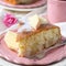 Slice of homemade apple sponge cake on pink plate