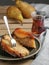 Slice of homemade pie with ricotta and caramelized pear on a black plate. Red tea in a glass of armudu next to the pie. Close-up