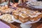 Slice of homemade walnut carrot cake with icing cream on white plate