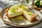 Slice of key lime pie with lime zest. Generative AI