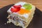 Slice of layered sponge cake with fruits decoration closeup