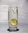 Slice of lemon dropped in glass of water