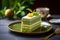 Slice of matcha biscuit cake with pistachio and vanilla layers on grey background. Sweet food concept. Pistachio dessert close up
