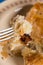 Slice of meat burek pie on the fork closeup macro