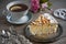 Slice of meringue cake and a cup of tea and flowers and pearls