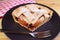 Slice of mouthwatering homemade apple pie on black plate