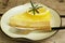 Slice of mouthwatering sweet and tart lemon cream cheese pie on a white plate