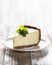 Slice of New York cheesecake with a sprig of mint