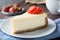 Slice of New York cheesecake on white plate