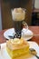 Slice of pear cream cake and cup of viennese coffee