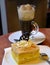 Slice of pear cream cake and glass cup viennese coffee