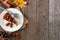 Slice of pecan caramel cheesecake, side border on rustic wood