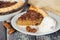 Slice of pecan pie served with ice cream