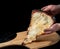 A slice of pizza from black dough lying on a wooden board-2.