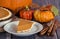 Slice of pumpkin pie with autumn decorations