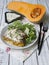 Slice of Pumpkin and Spinach Lasagne with blue cheese and salad on a White Wooden Table. Selective focus, copy space