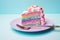 a slice of rainbow cake with a fork on a plate