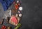 Slice of Raw Beef sirlion steak on wooden chopping board with tomatoes,garlic and asparagus tips and meat hatchet. Space for text