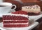 Slice of red velvet cake on a white plate. Close up of red velvet chocolate cake and tiramisu coffee cake
